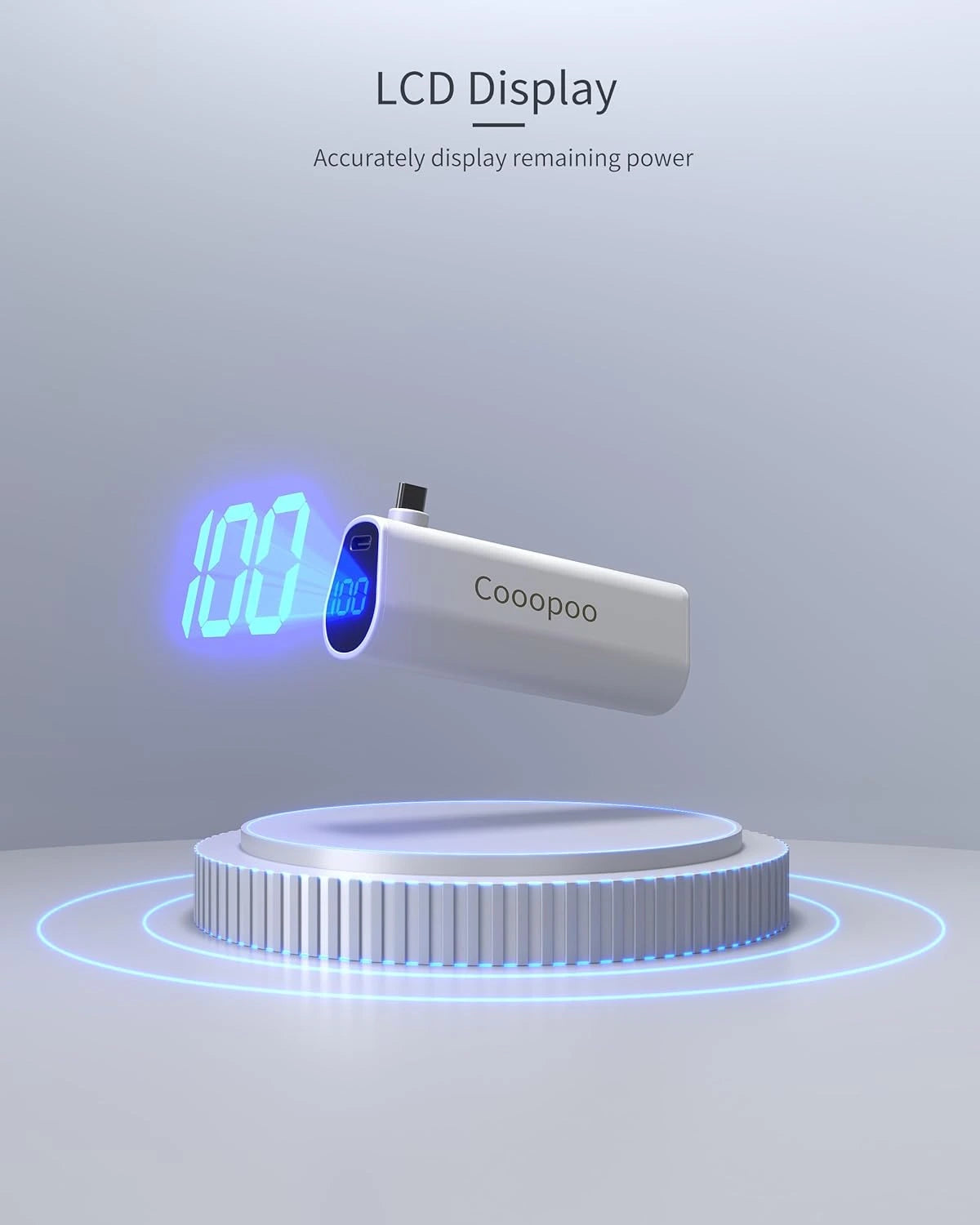 A white power bank with "Cooopoo" branding, showcasing an LCD displaying 100% power, placed on a futuristic circular platform—a perfect addition to your gaming and VR accessories.