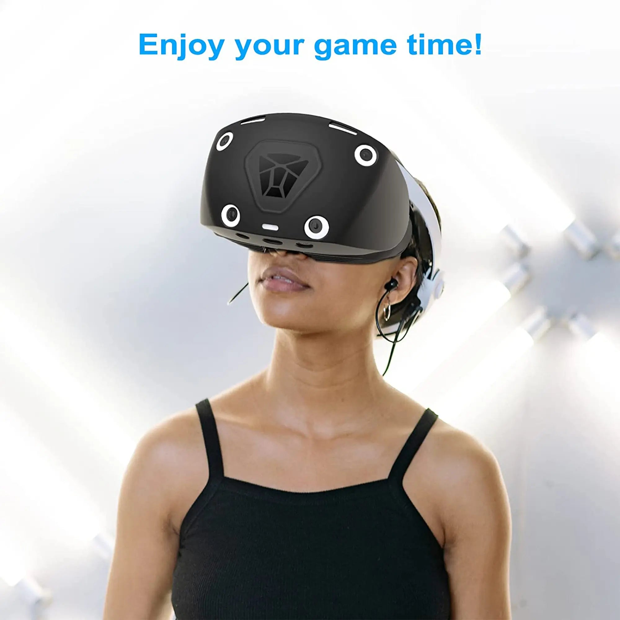 Person in black tank top wearing a VR headset with "Enjoy your game time!" text above, surrounded by vr accessories against a futuristic background.