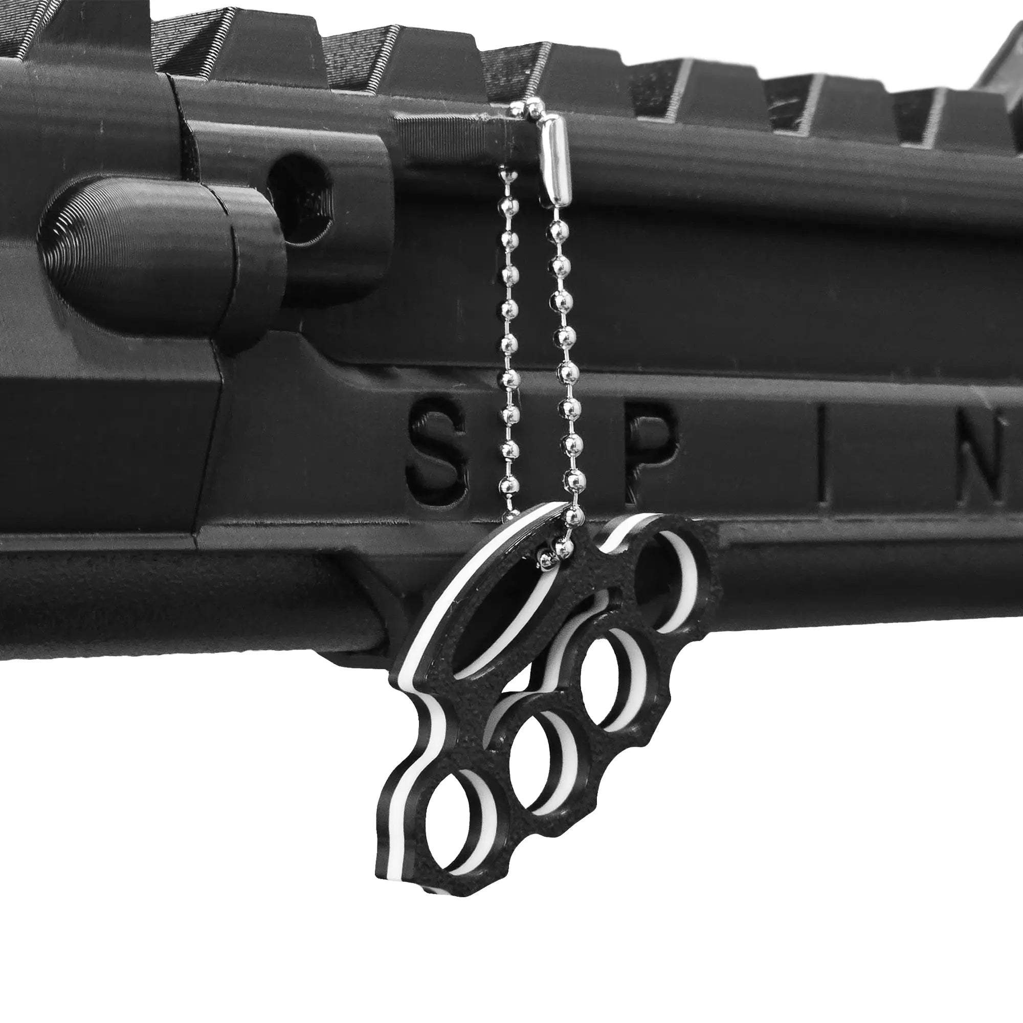 Knuckle duster keychain hanging from a SPINE VR Gun Stock using a ball chain 